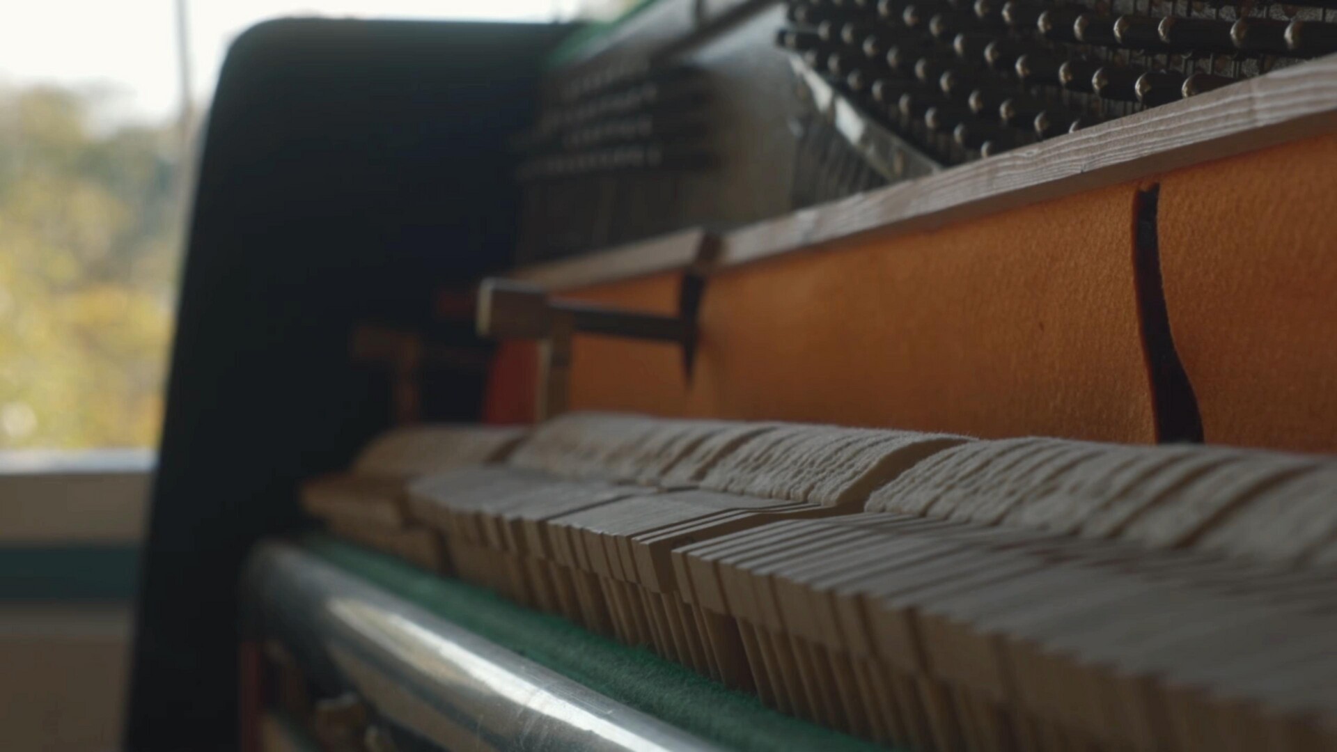 The intricate mechanics and keys of a piano, ready to create music.