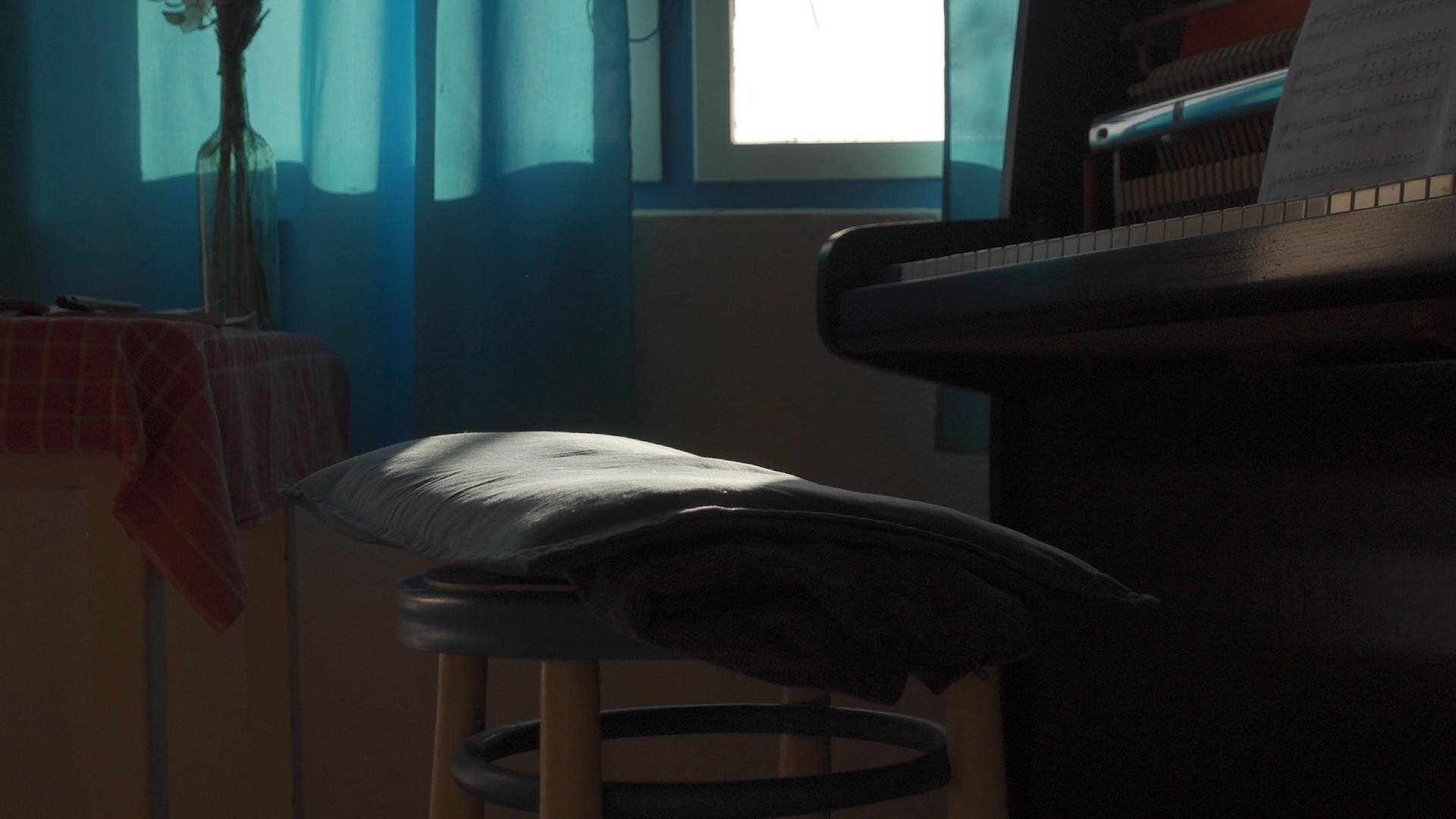 A piano bathed in natural light, suggesting a moment of musical inspiration.