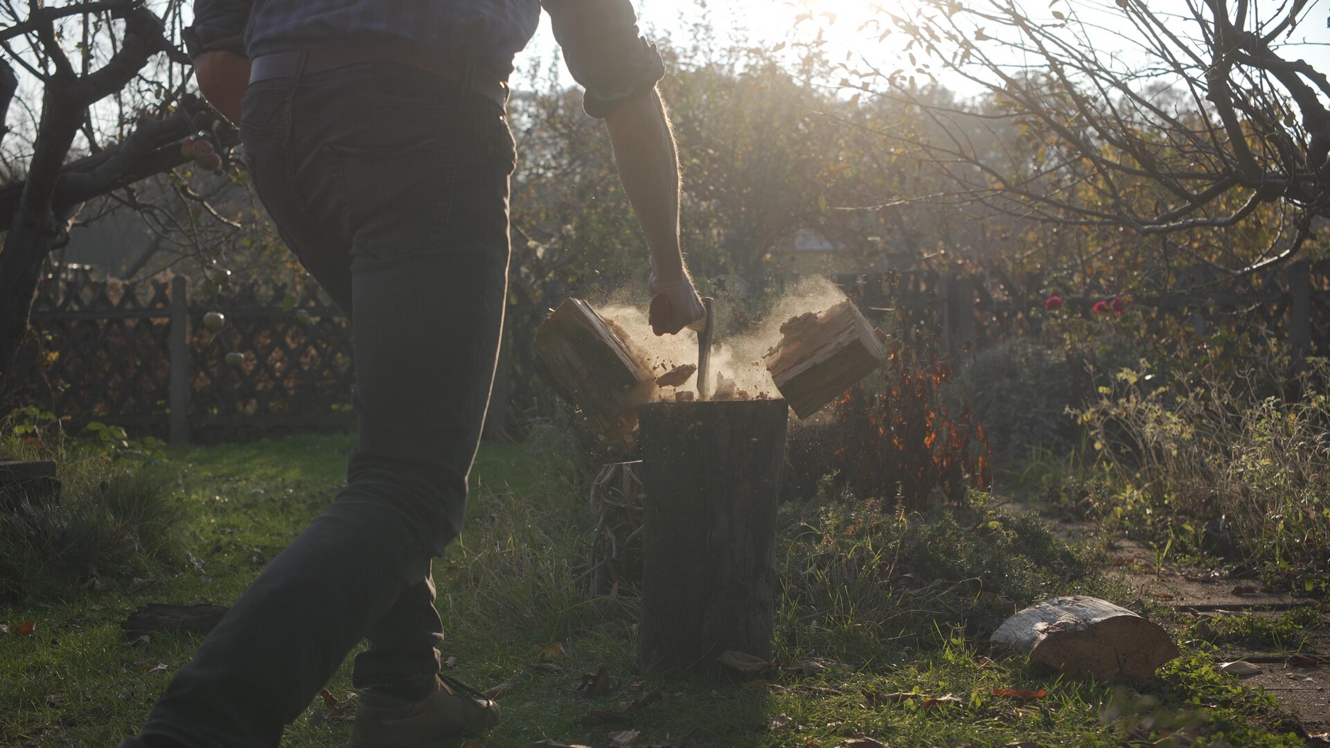 Crafting art from wood under the warm glow of the setting sun.