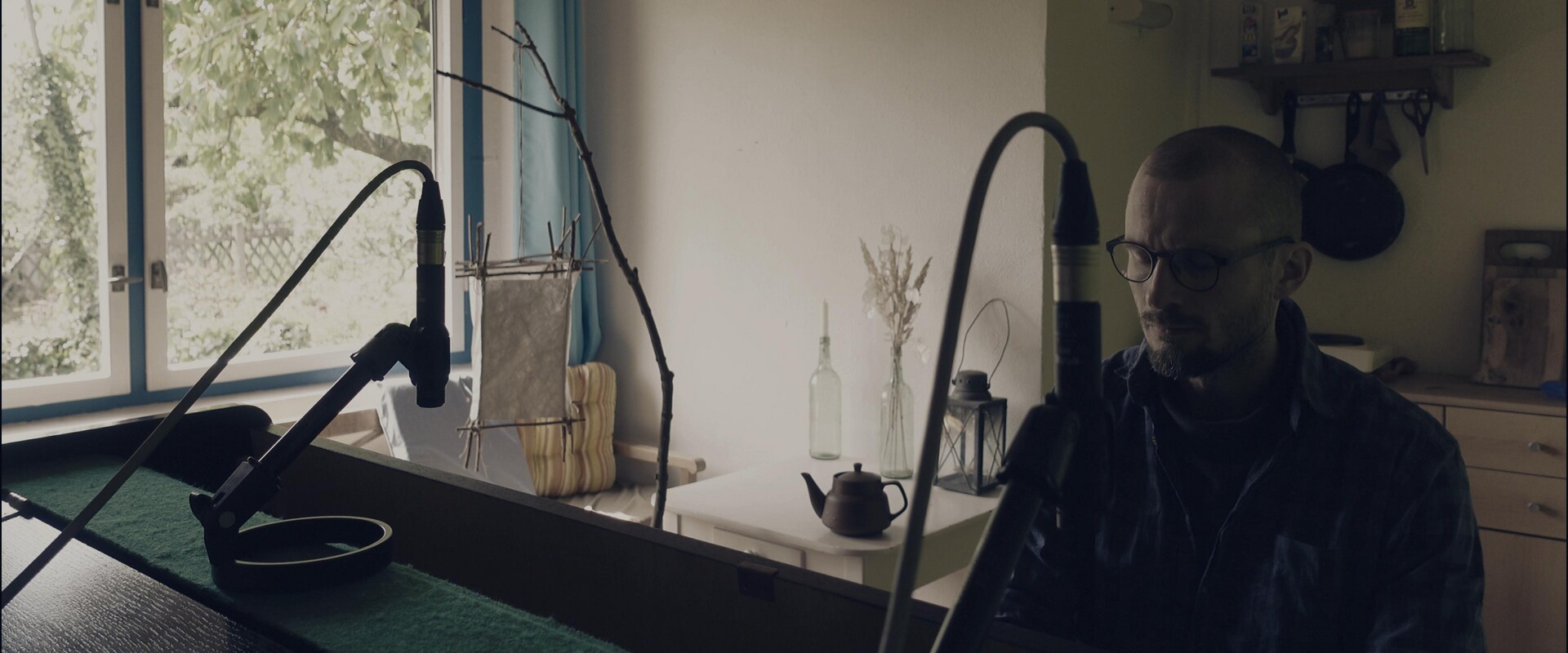 A moment of quiet reflection at the piano, bathed in natural light.